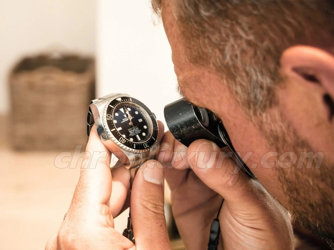 A replica watch is inspected for accuracy, ensuring that readers visualize the thorough QC process