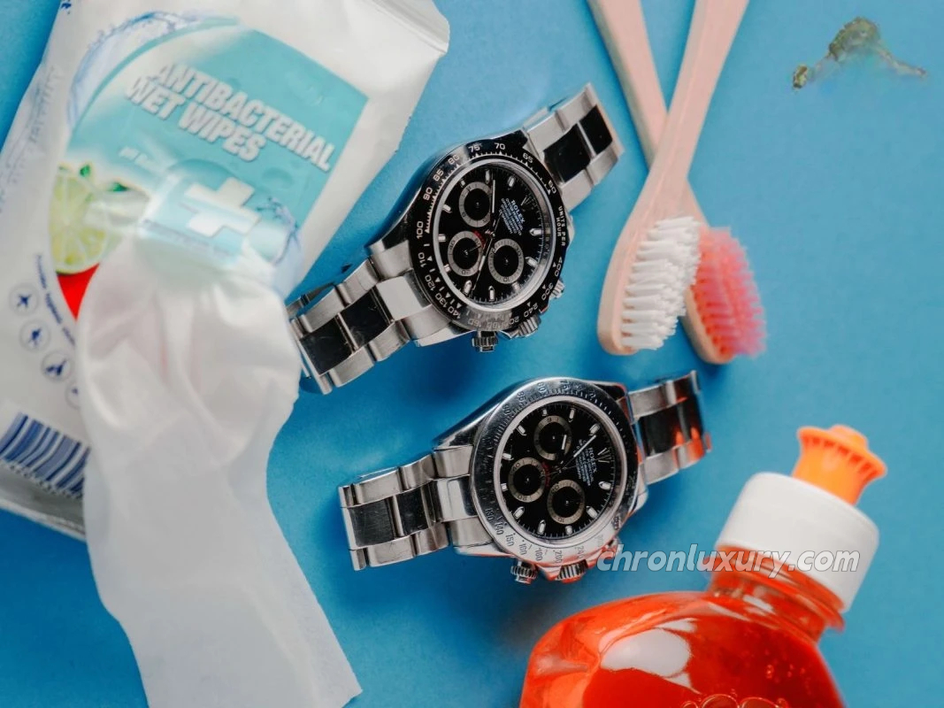 Tools for cleaning a Rolex replica watch, including a microfiber cloth, brush, and soap